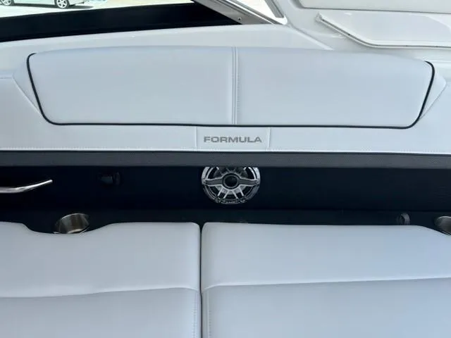 Slide: The Image of 2024 Formula 310 CBR boat interior with white leather seating and speaker. - 21