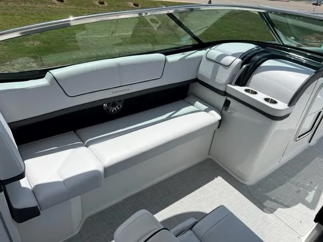 Slide: The Image of 2024 Formula 310 CBR boat interior with white seating and cup holders. - 5