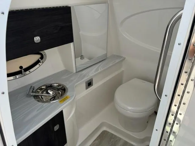 Slide: The Image of 2024 Formula 310 CBR boat bathroom with sink, mirror, and toilet. - 9