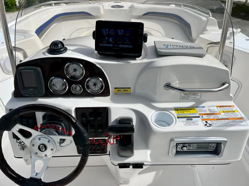 Slide: The Image of 2011 Hurricane 231 boat dashboard with Garmin GPS and control panel. - 11
