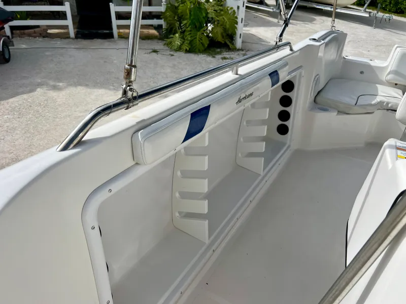 Slide: The Image of 2011 Hurricane 231 boat interior with rod holders and seating. - 14