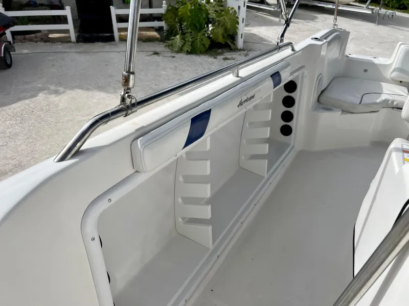 Slide: The Image of 2011 Hurricane 231 boat interior with seating and storage compartments. - 15