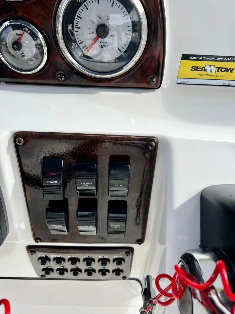 Slide: The Image of Control panel of a 2011 Hurricane 231 boat with gauges and switches. - 18