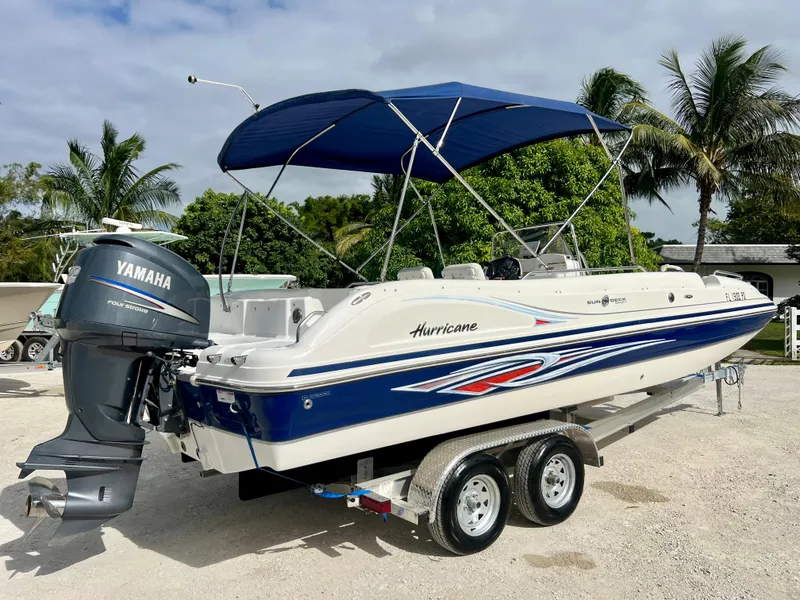 Slide: The Image of 2011 Hurricane 231 boat with Yamaha outboard motor and blue canopy. - 20