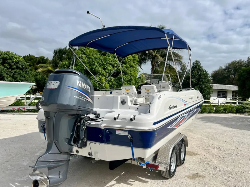Slide: The Image of 2011 Hurricane 231 boat with Yamaha outboard motor and blue canopy. - 21