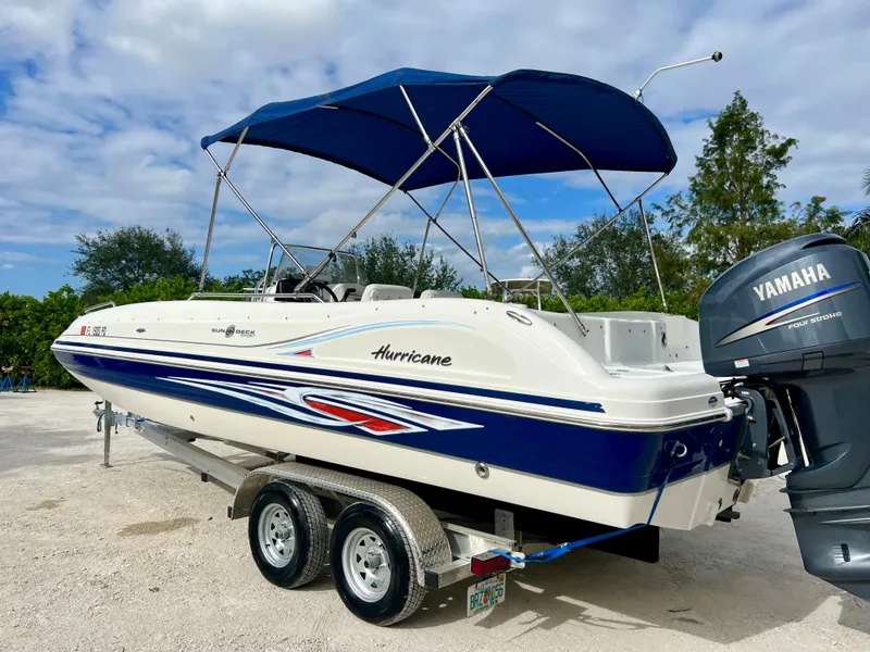 Slide: The Image of 2011 Hurricane 231 boat with Yamaha outboard motor on trailer. - 23