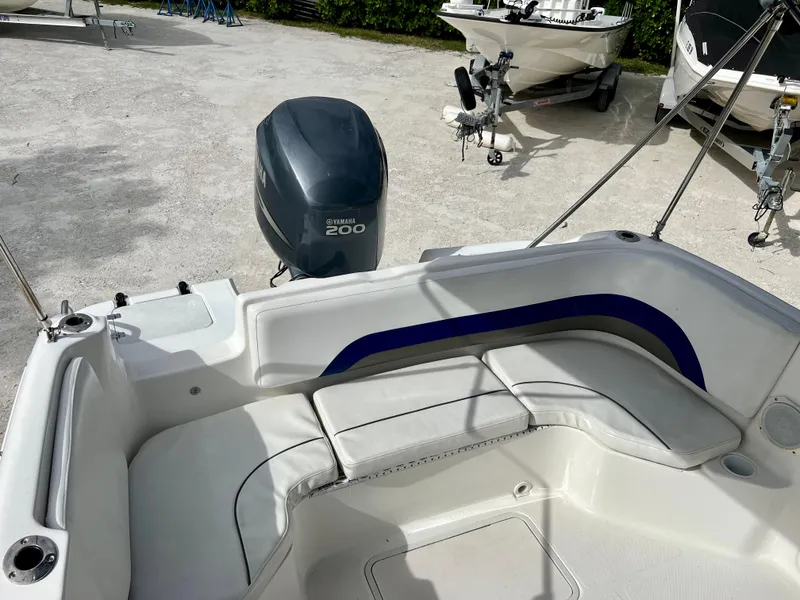 Slide: The Image of 2011 Hurricane 231 boat with Yamaha 200 outboard motor, white and blue seating. - 24