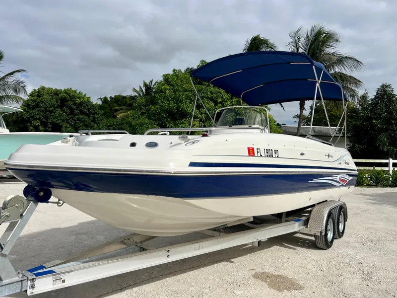 Slide: The Image of 2011 Hurricane 231 boat on trailer with blue canopy. - 3