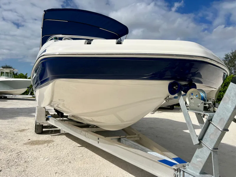 Slide: The Image of 2011 Hurricane 231 boat on a trailer under a blue sky. - 6