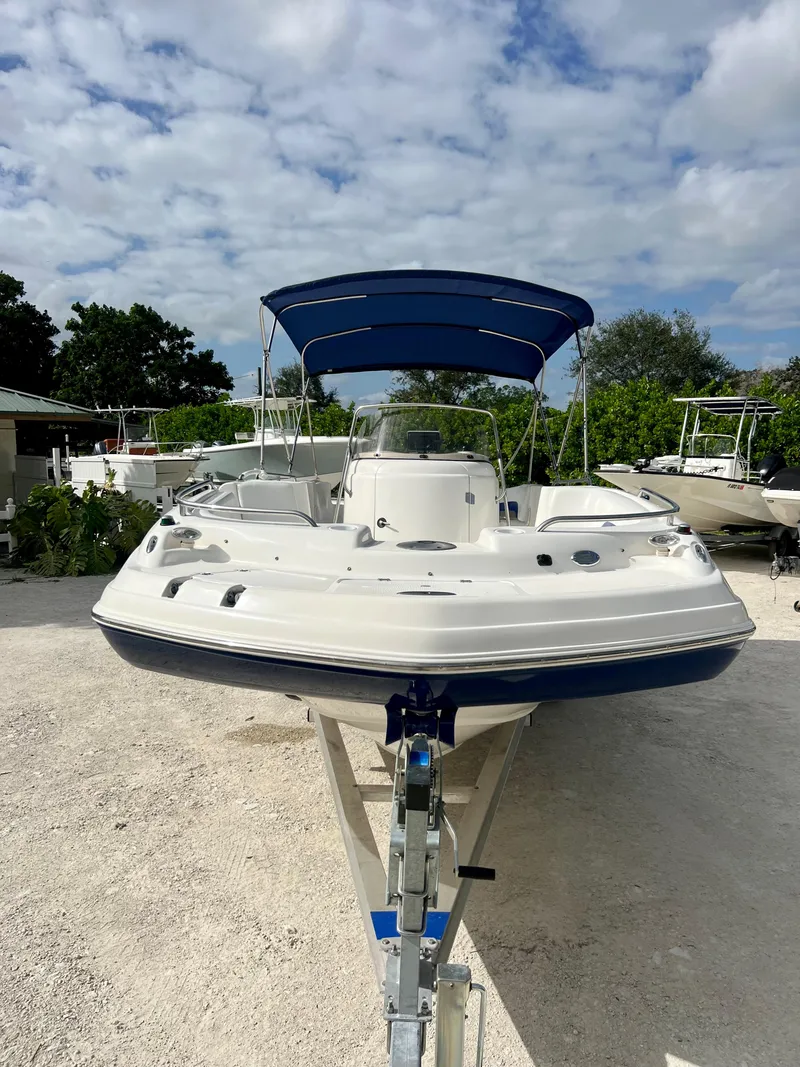 Slide: The Image of 2011 Hurricane 231 boat with blue canopy on trailer. - 7