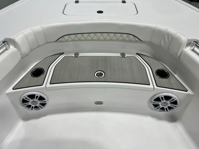 Slide: The Image of 2024 Sportsman Masters 267OE Bay boat interior with speakers and cup holders. - 13