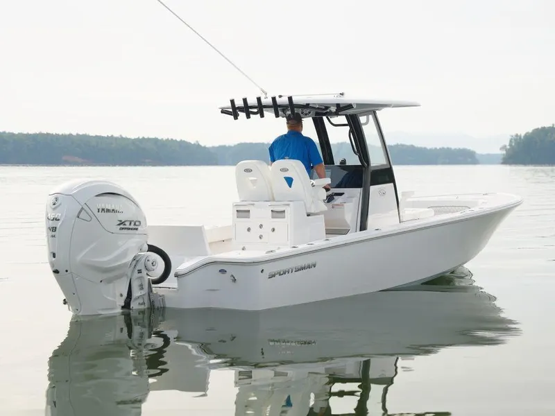 Slide: The Image of 2024 Sportsman Masters 267OE Bay boat on calm water, rear view. - 14