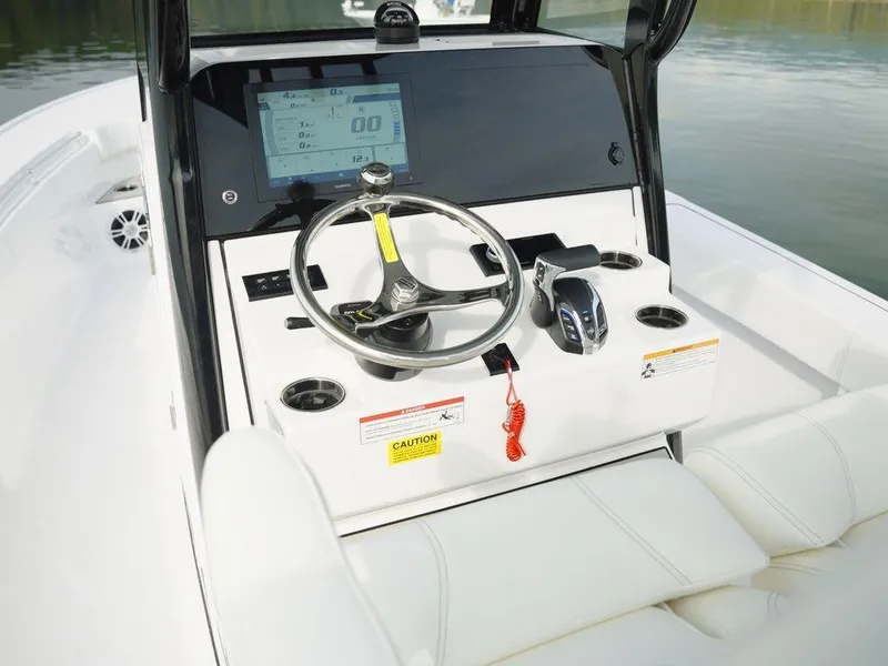 Slide: The Image of 2024 Sportsman Masters 267OE Bay boat dashboard with steering wheel and digital display. - 15