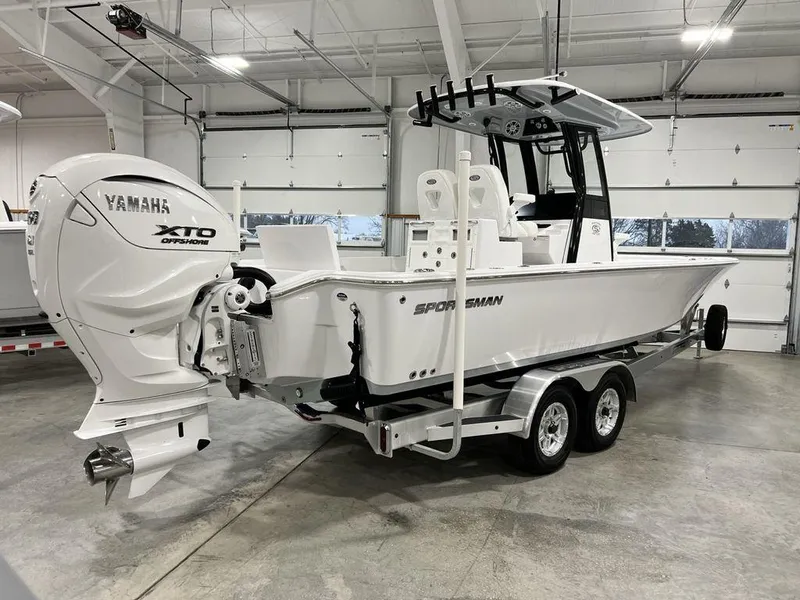 Slide: The Image of 2024 Sportsman Masters 267OE Bay boat with Yamaha XTO engine in a garage. - 17