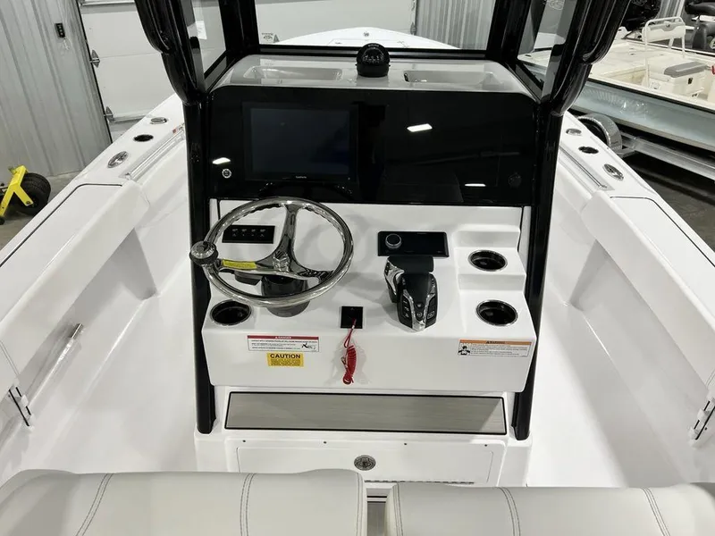 Slide: The Image of 2024 Sportsman Masters 267OE Bay boat console with steering wheel and controls. - 23
