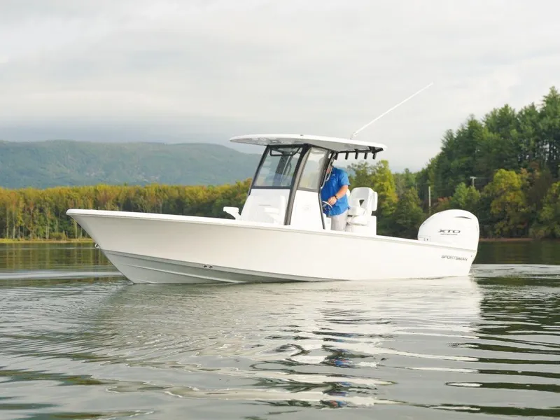 Slide: The Image of 2024 Sportsman Masters 267OE Bay boat on calm water, scenic background. - 24