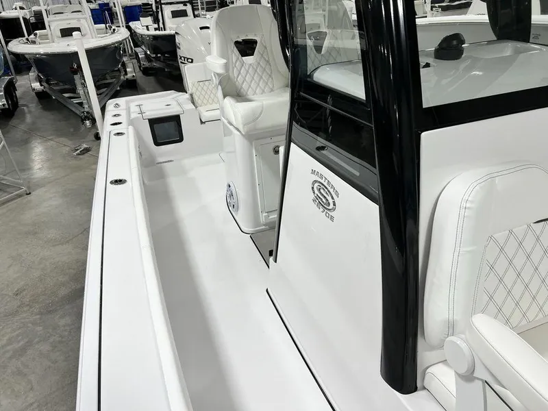 Slide: The Image of 2024 Sportsman Masters 267OE Bay boat interior with white seating and sleek design. - 28