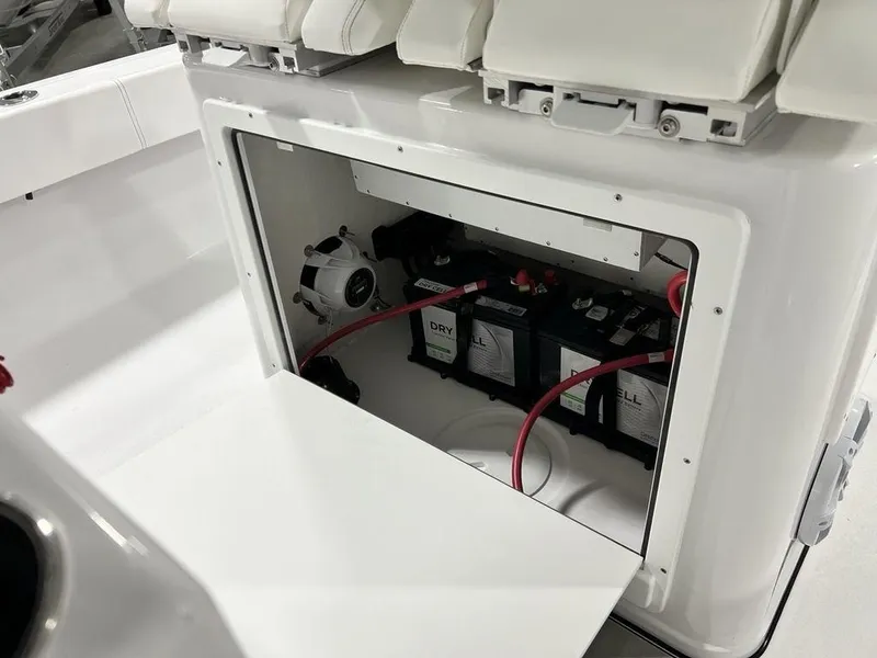 Slide: The Image of 2024 Sportsman Masters 267OE Bay boat battery compartment with wiring and storage. - 32