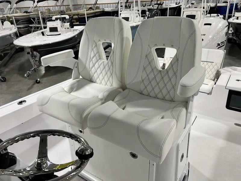 Slide: The Image of 2024 Sportsman Masters 267OE Bay boat with luxurious white seating and steering wheel. - 44