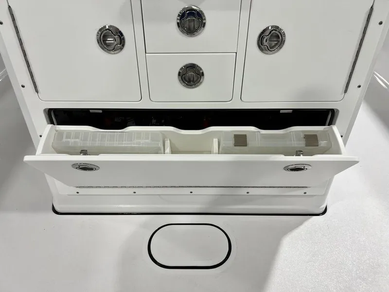 Slide: The Image of 2024 Sportsman Masters 267OE Bay boat storage compartment with open drawer. - 47
