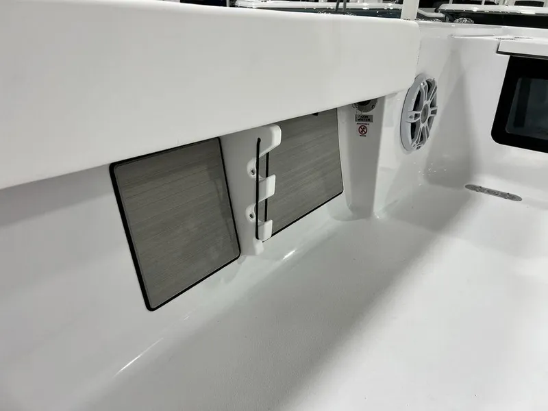 Slide: The Image of 2024 Sportsman Masters 267OE Bay boat interior with speaker and storage compartments. - 49