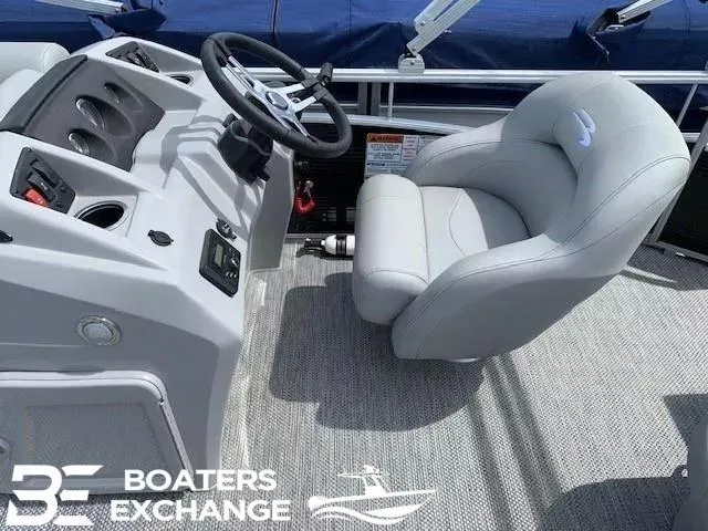 Slide: The Image of 2024 Bennington 188SVL boat interior with steering console and plush captain's chair. - 4