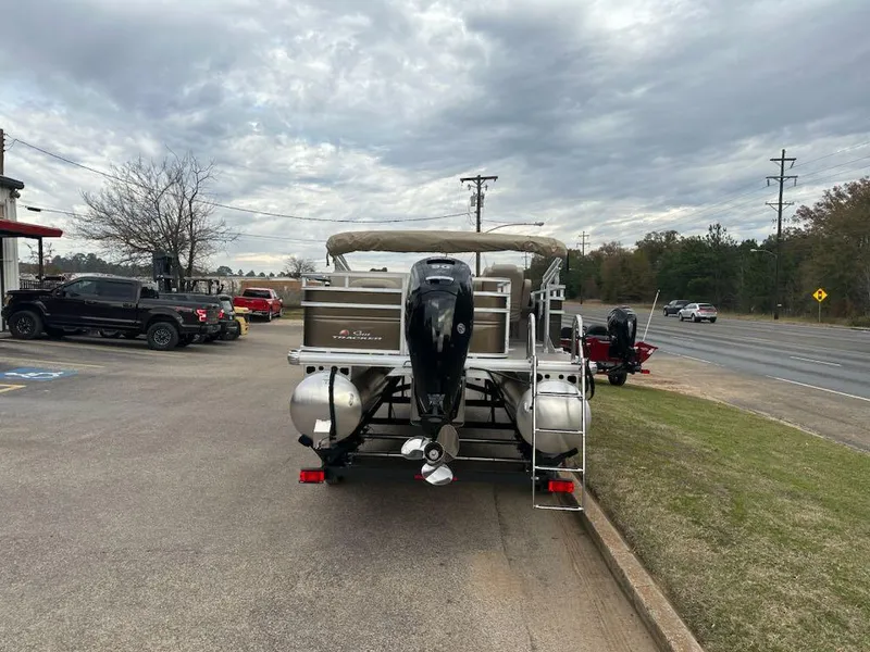 Slide: The Image of 2024 Sun Tracker SportFish 20 DLX pontoon boat parked on a lot. - 2