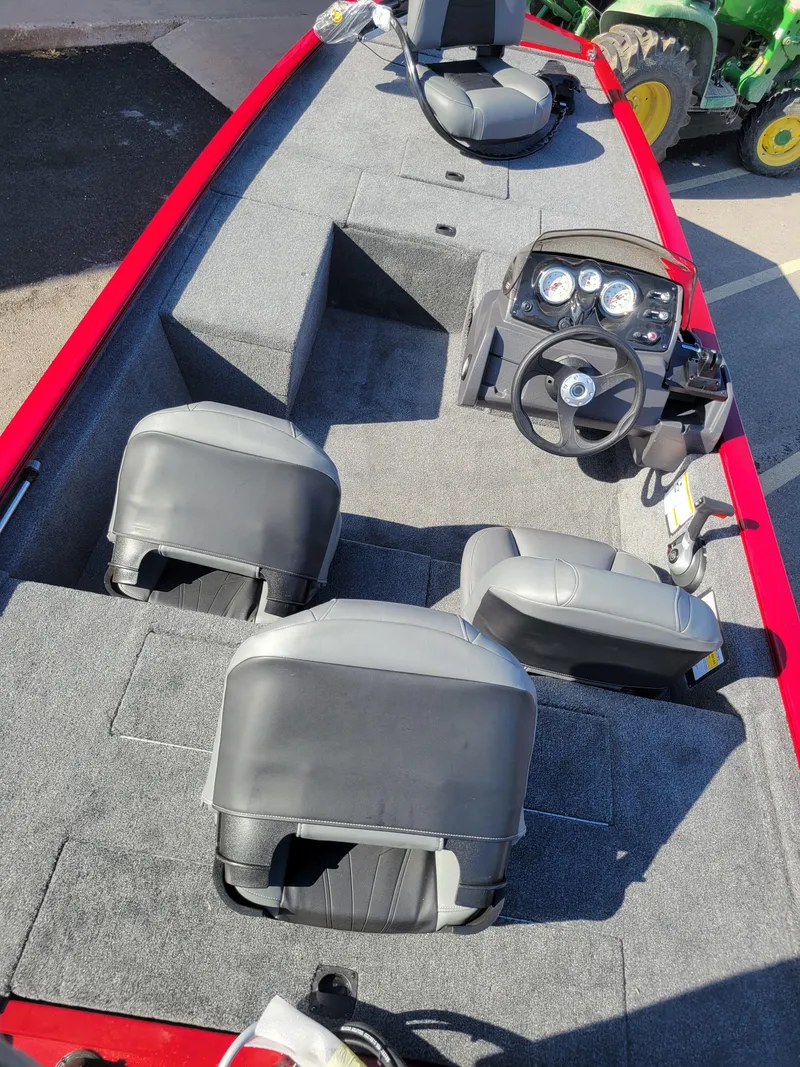 Slide: The Image of 2024 Tracker Pro 170 fishing boat interior with seating and steering console. - 13