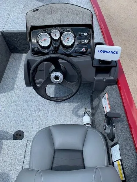Slide: The Image of 2024 Tracker Pro 170 boat dashboard with steering wheel and Lowrance fish finder. - 14