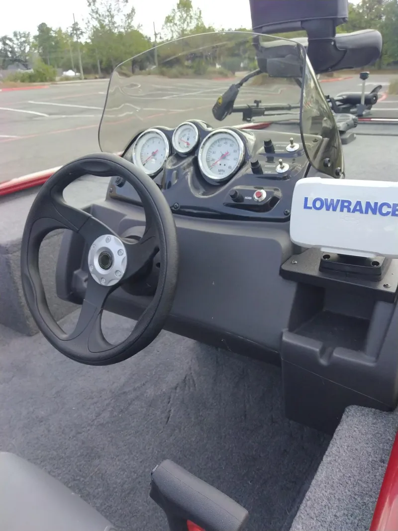 Slide: The Image of 2024 Tracker Pro 170 boat dashboard with steering wheel and Lowrance fish finder. - 15