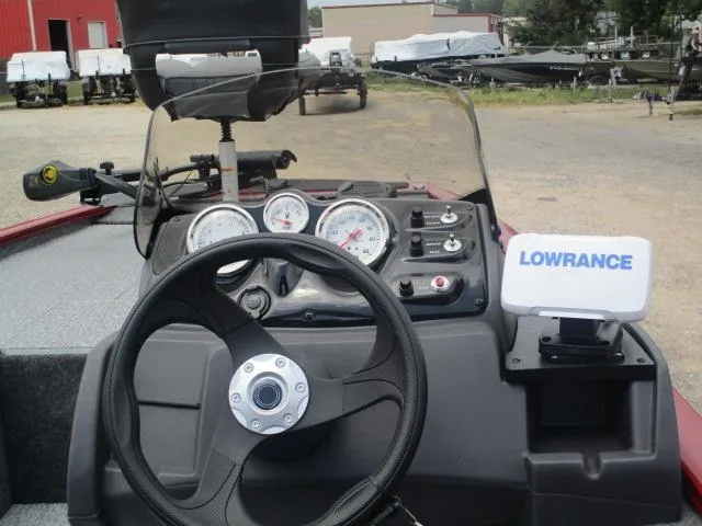 Slide: The Image of 2024 Tracker Pro 170 boat dashboard with steering wheel, gauges, and Lowrance fish finder. - 16