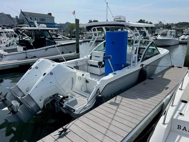 Slide: The Image of 2021 Blackfin 252 DC boat docked at a marina with other boats. - 3