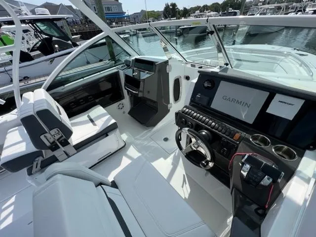 Slide: The Image of 2021 Blackfin 252 DC boat interior with Garmin navigation system and white seating. - 5