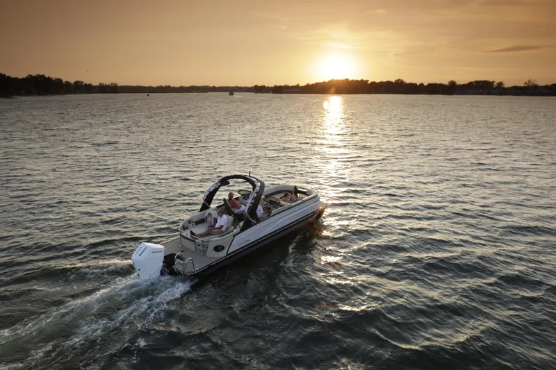 Slide: The Image of 2024 Sylvan G5 CLZ DC boat cruising on a lake at sunset. - 11