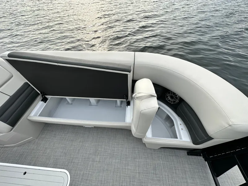 Slide: The Image of 2024 Sylvan G5 CLZ DC boat with open storage compartment on water. - 14