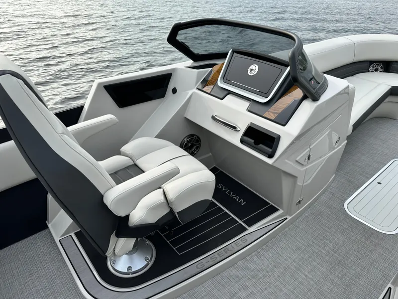 Slide: The Image of 2024 Sylvan G5 CLZ DC boat cockpit with captain's chair and control panel. - 16