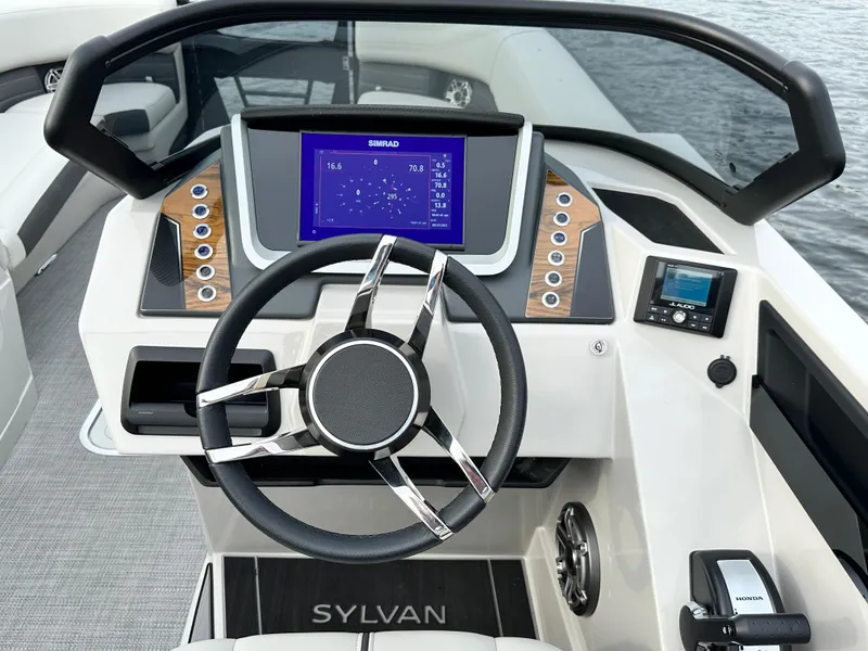 Slide: The Image of 2024 Sylvan G5 CLZ DC boat dashboard with modern steering wheel and digital display. - 17