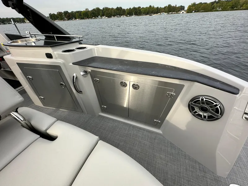 Slide: The Image of 2024 Sylvan G5 CLZ DC boat interior with stainless steel storage and speaker. - 19