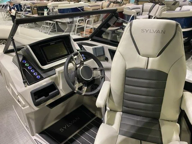 Slide: The Image of 2024 Sylvan G5 CLZ DC boat cockpit with modern steering and control panel. - 2