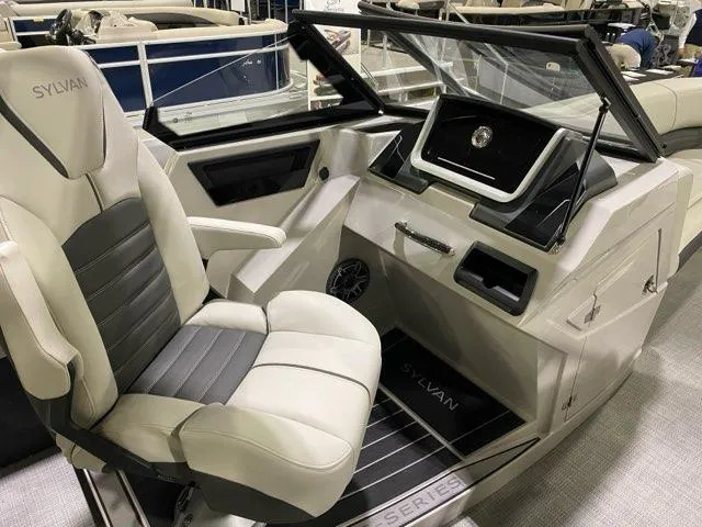 Slide: The Image of 2024 Sylvan G5 CLZ DC boat cockpit with captain's chair and modern dashboard. - 3