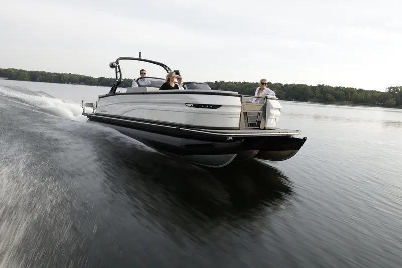 Slide: The Image of 2024 Sylvan G5 CLZ DC pontoon boat cruising on a lake. - 7