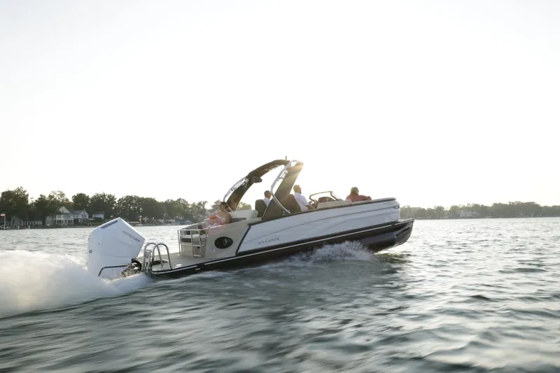 Slide: The Image of 2024 Sylvan G5 CLZ DC boat cruising on a lake at sunset. - 9