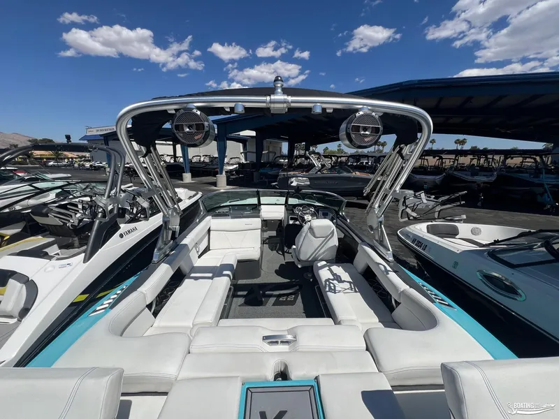 Slide: The Image of 2018 MasterCraft XT22 boat interior with white seating and wakeboard tower. - 10