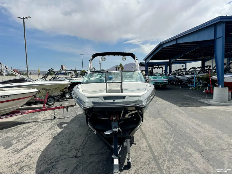 Slide: The Image of 2018 MasterCraft XT22 boat on trailer in a marina with other boats. - 3