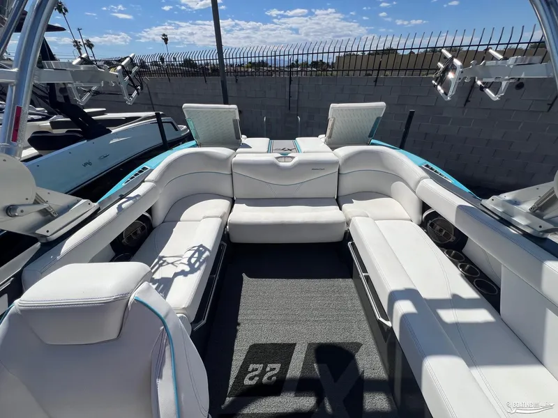 Slide: The Image of 2018 MasterCraft XT22 boat interior with white seating and wakeboard racks. - 8
