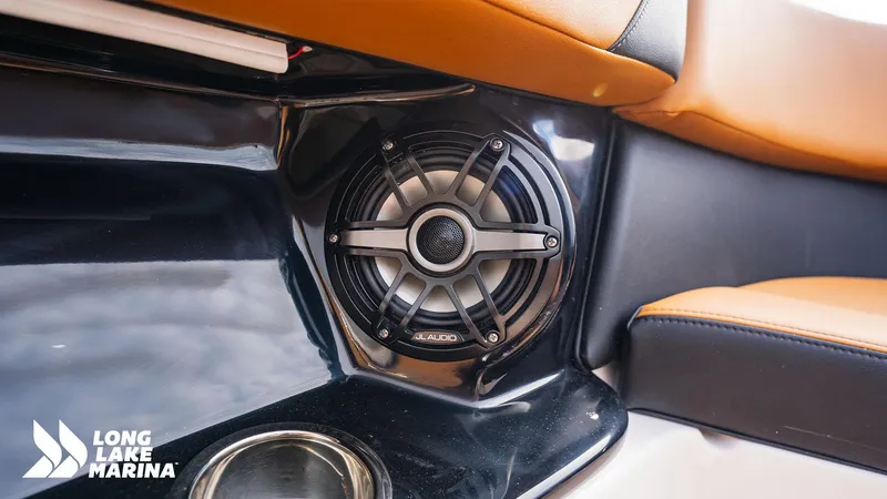 Slide: The Image of 2024 Chaparral 300 OSX boat interior with JL Audio speaker and orange seating. - 10