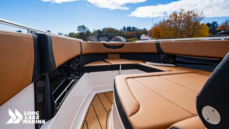 Slide: The Image of 2024 Chaparral 300 OSX boat interior with tan seating at Long Lake Marina. - 11