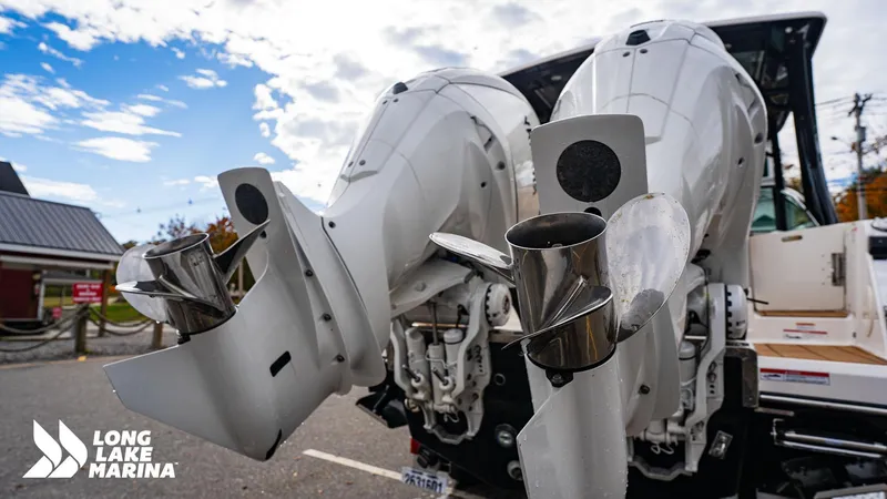 Slide: The Image of 2024 Chaparral 300 OSX boat engines at Long Lake Marina under a partly cloudy sky. - 12