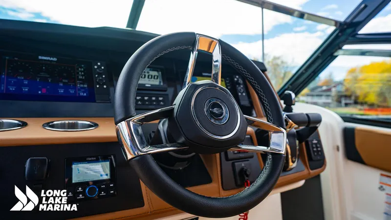Slide: The Image of 2024 Chaparral 300 OSX boat dashboard with steering wheel and navigation controls. - 16