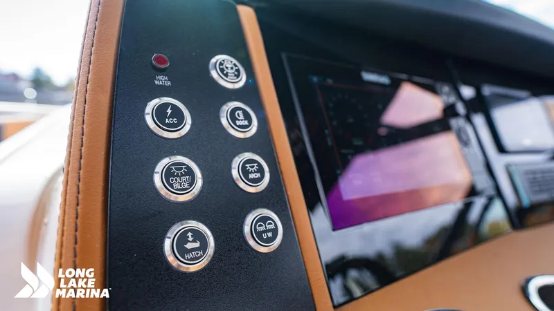 Slide: The Image of 2024 Chaparral 300 OSX dashboard with control buttons and display at Long Lake Marina. - 17